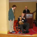 Mel Warren donates the AOW Challenge Trophy retired by the Levittown Skating Club to Chester Fried of the Roller Skaters Museum.